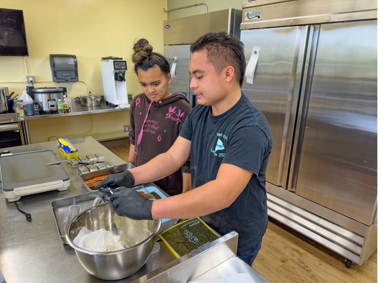 Team members preparing food together in the kitchen