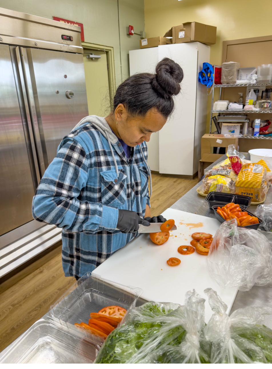 Team member slicing fresh tomatoes