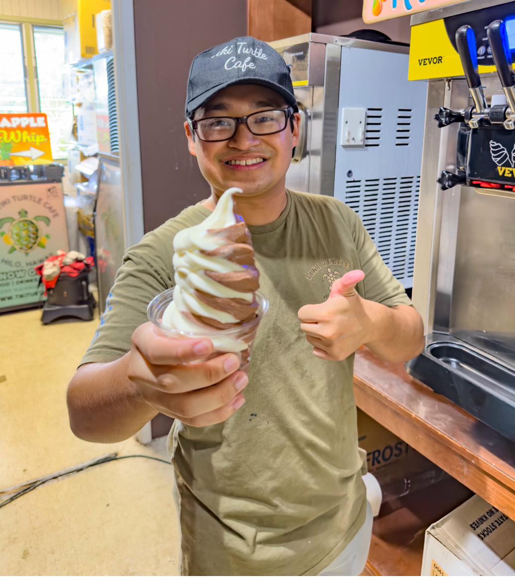 Team member serving Dole Whip with a shaka